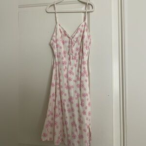 White mini dress with spaghetti strap and pink floral detail